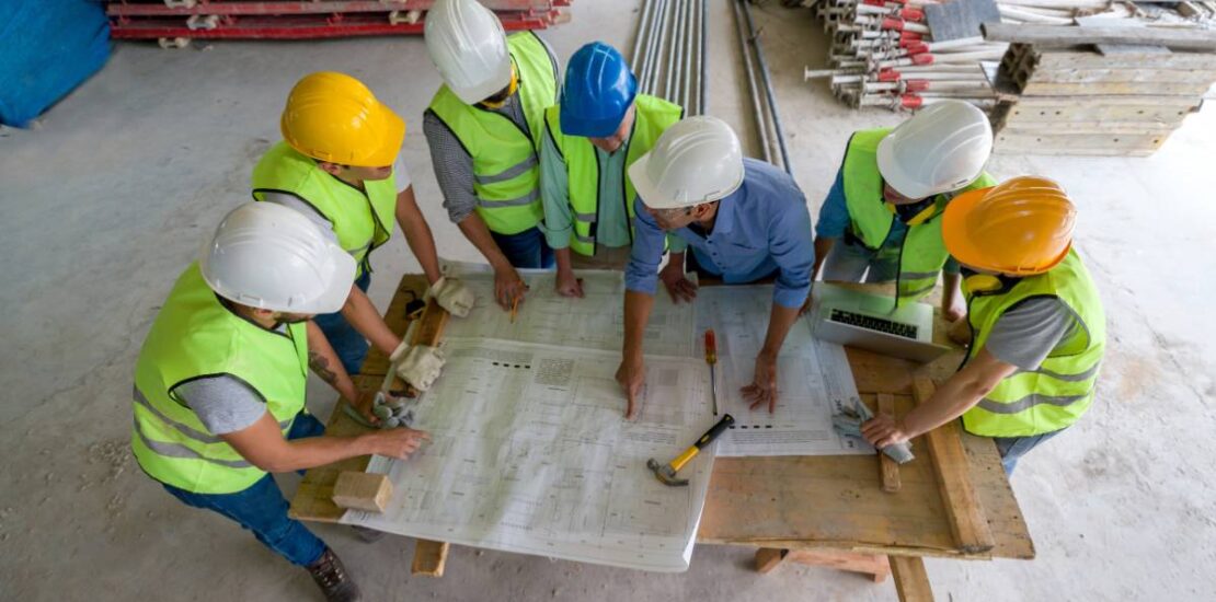 Construction team collaborating on site plans