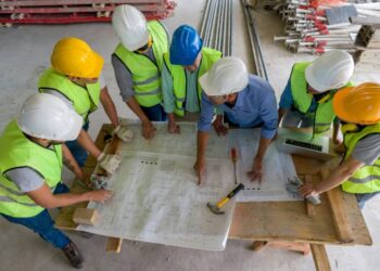 Construction team collaborating on site plans