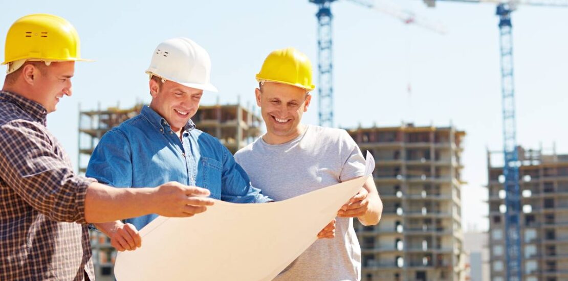 Contractor discussing project plans with a team of local trades.