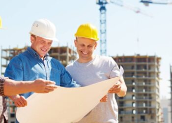 Contractor discussing project plans with a team of local trades.