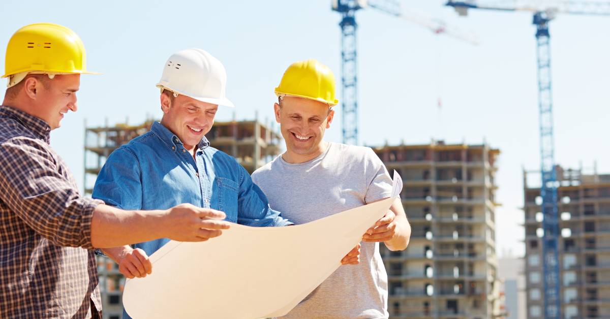 Contractor discussing project plans with a team of local trades.